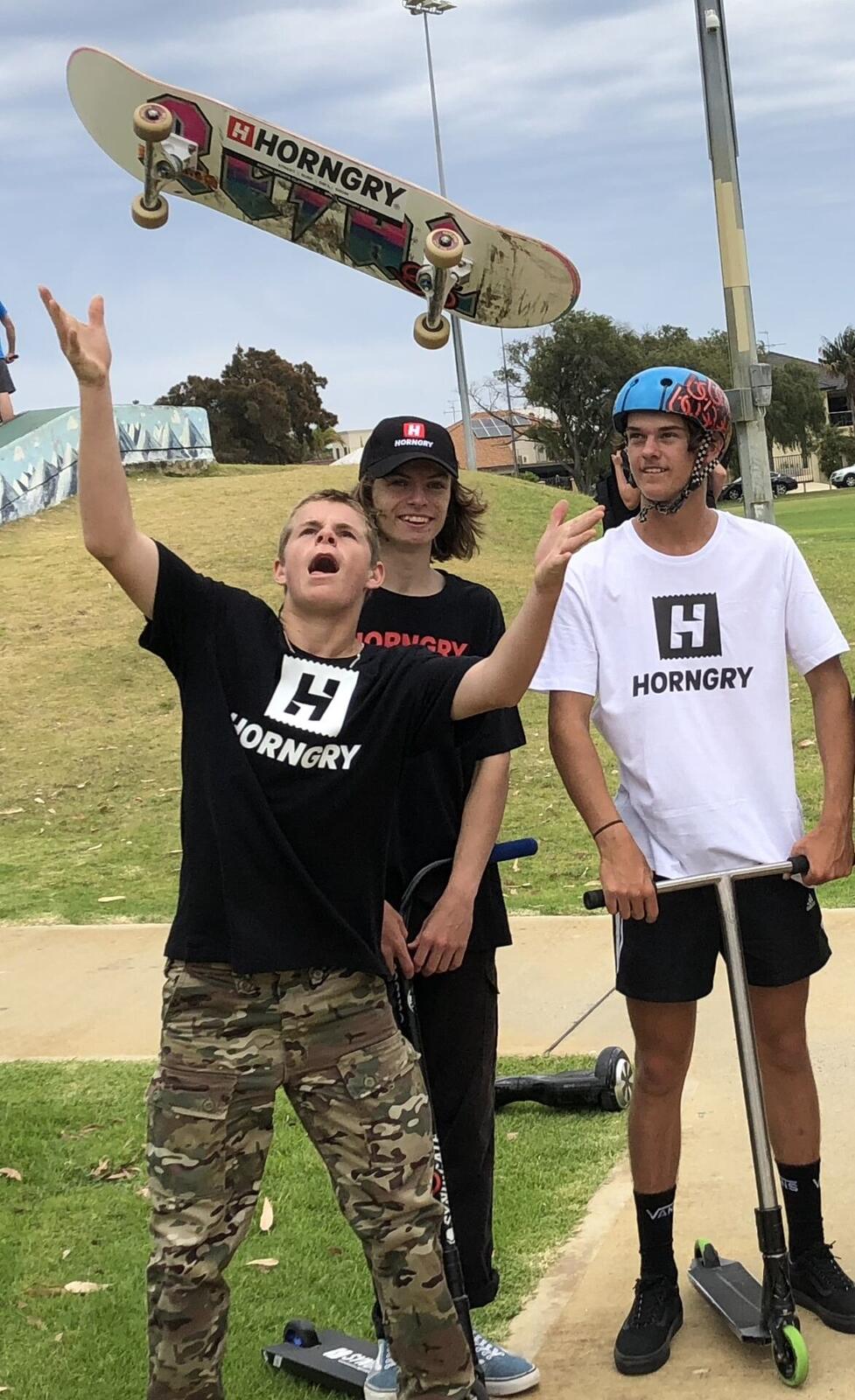Young HORNGRY riders with their scooters at a skatepark